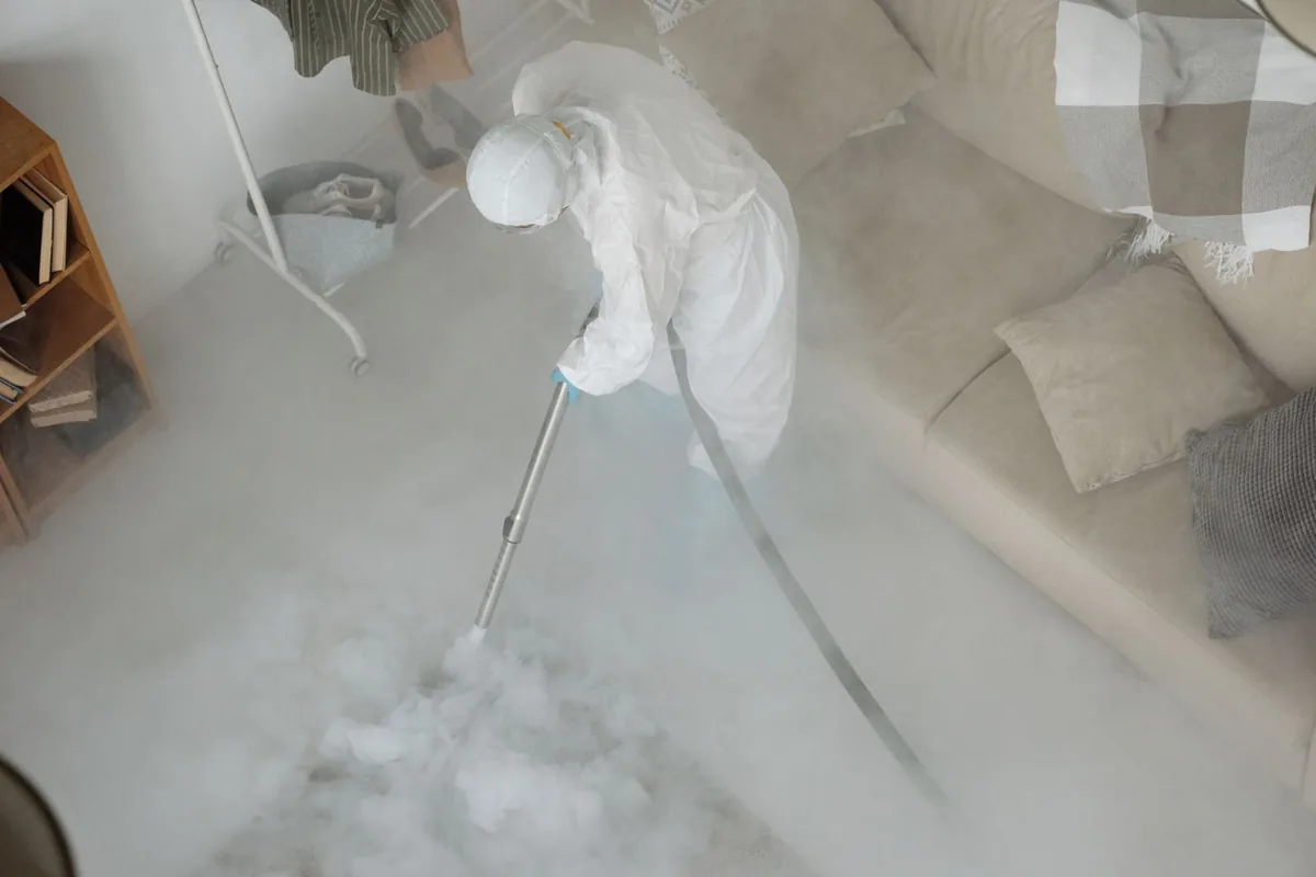 Biohazard cleanup technician in protective equipment, Springmont, PA